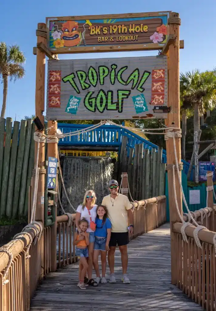 Family in front of Tropical Golf