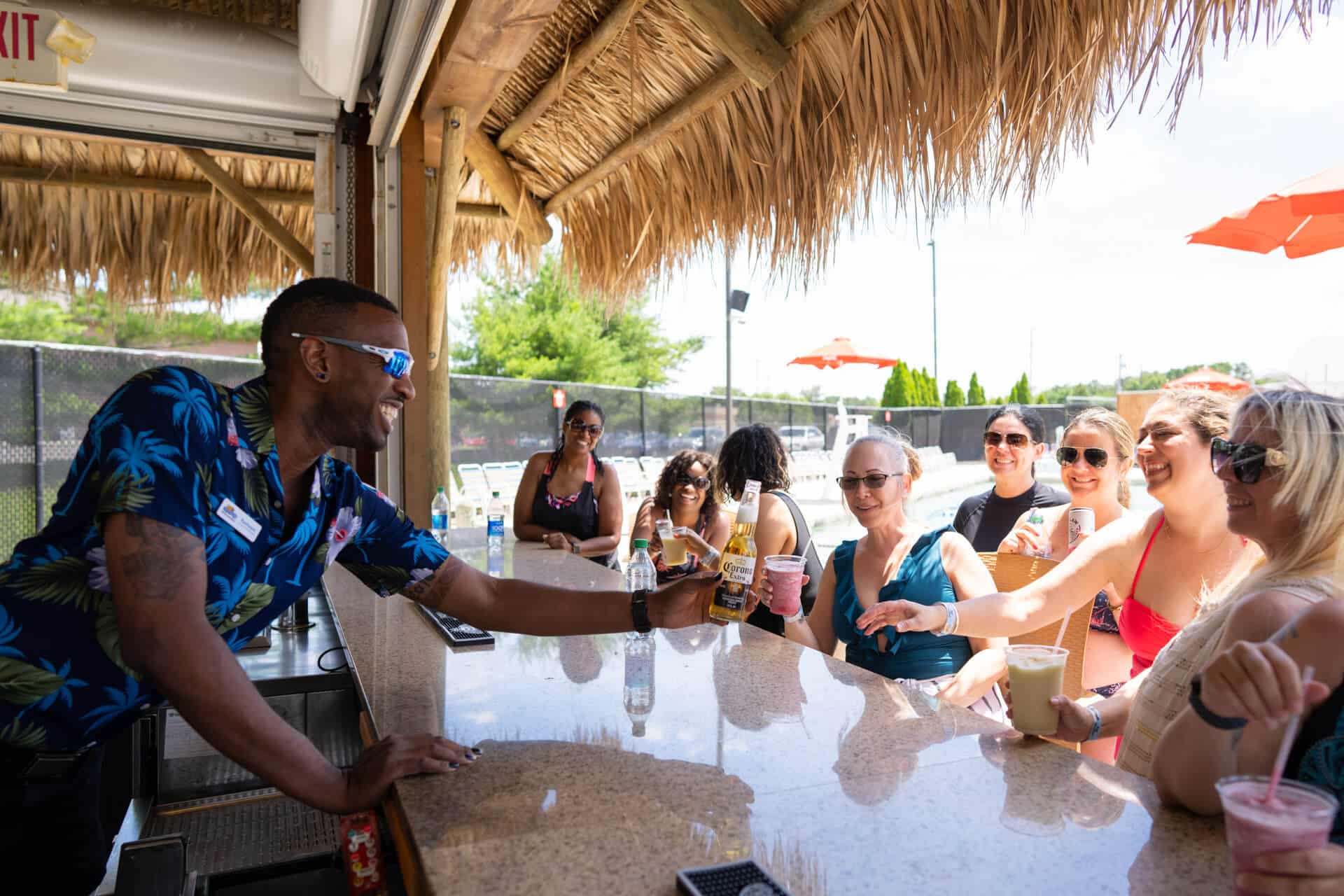 women enjoying drinks at outdoor tiki bar