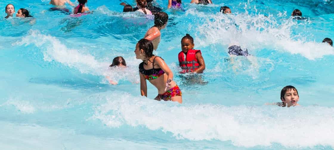 children splash in the wave pool